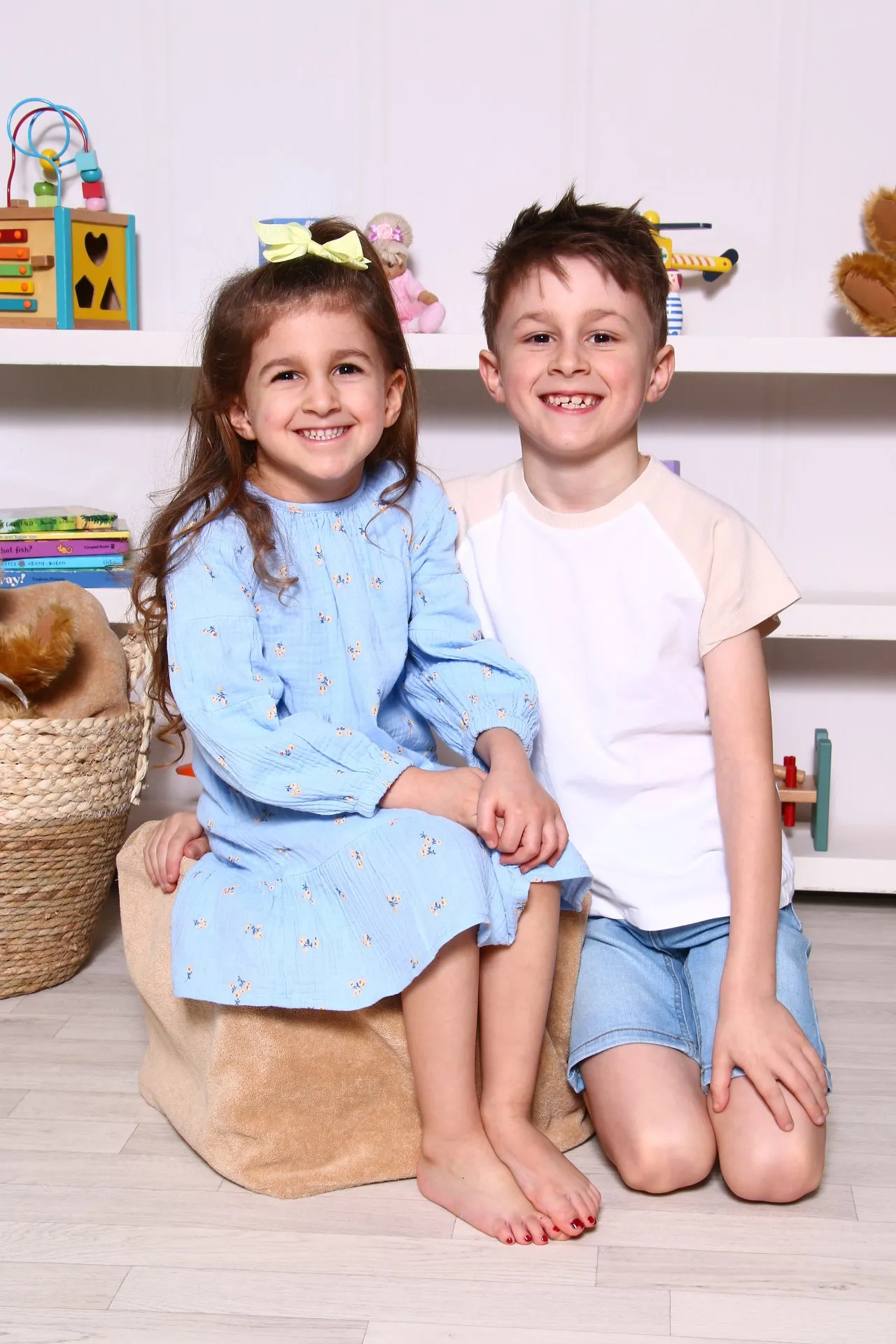 Two children sitting together infront of Toy Scene