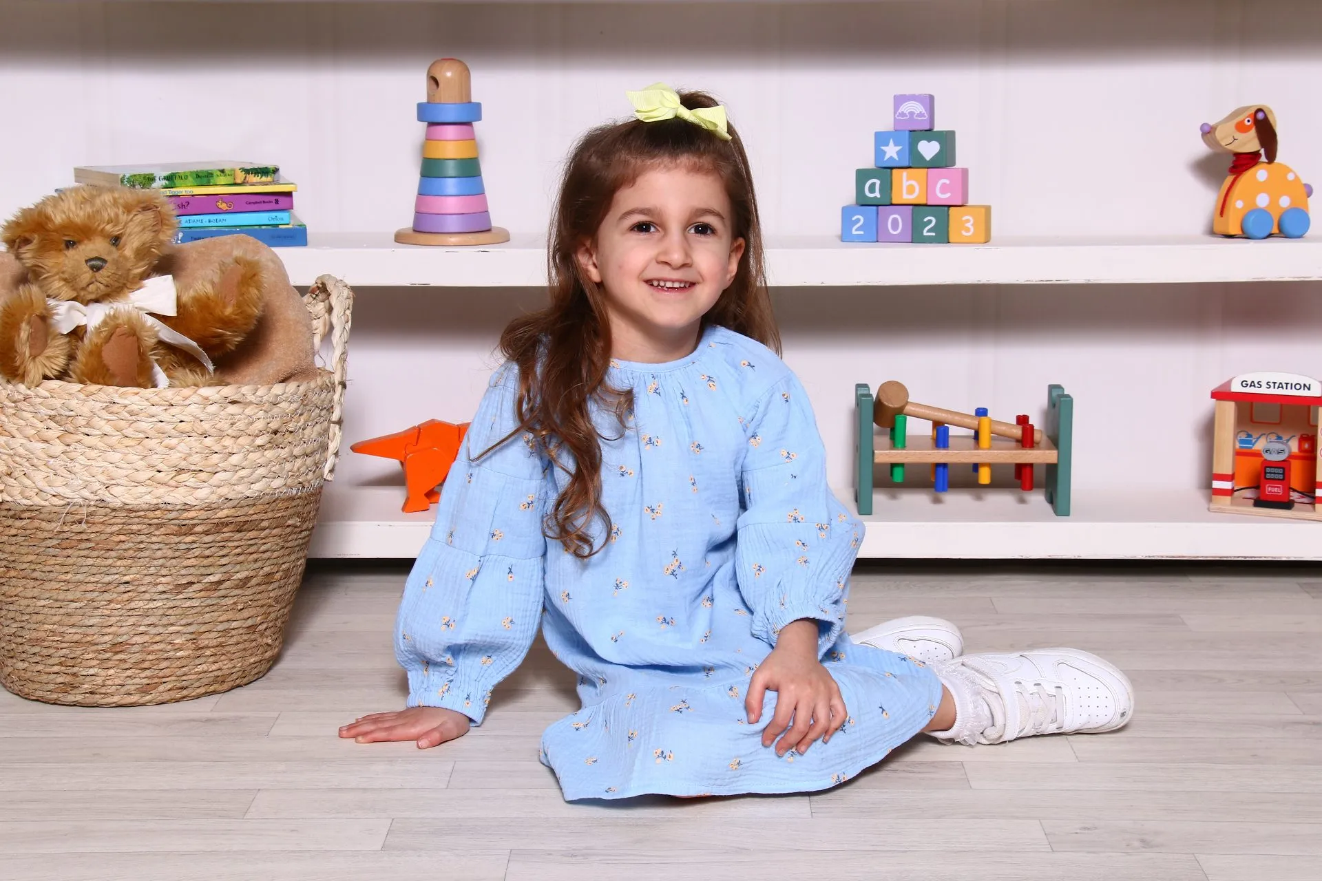 A nursery child infront of toy scene